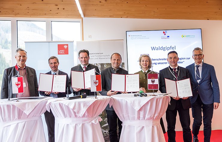 © Land Tirol/Groder Personen stehen nebeneinander und halten Urkunde