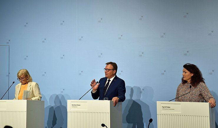 © Land Tirol/Krepper Palfrader, Platter und Felipe nebeneinander an ihren Rednerpulten stehend