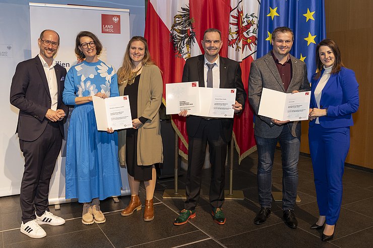 sechs Personen mit Urkunden