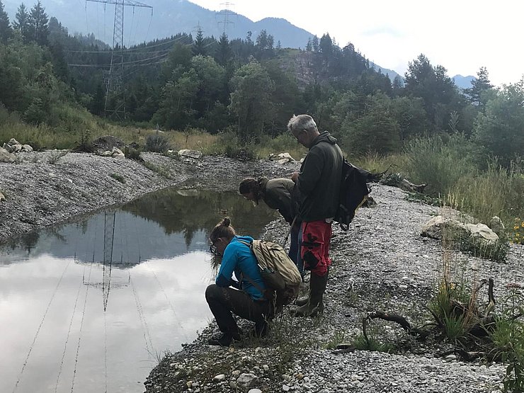 Menschen an einem kleinen Teich