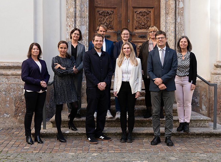 Das Bild zeigt die Mitglieder der Gleichbehandlungskommission auf einer Stiege vor der Georgskapelle.