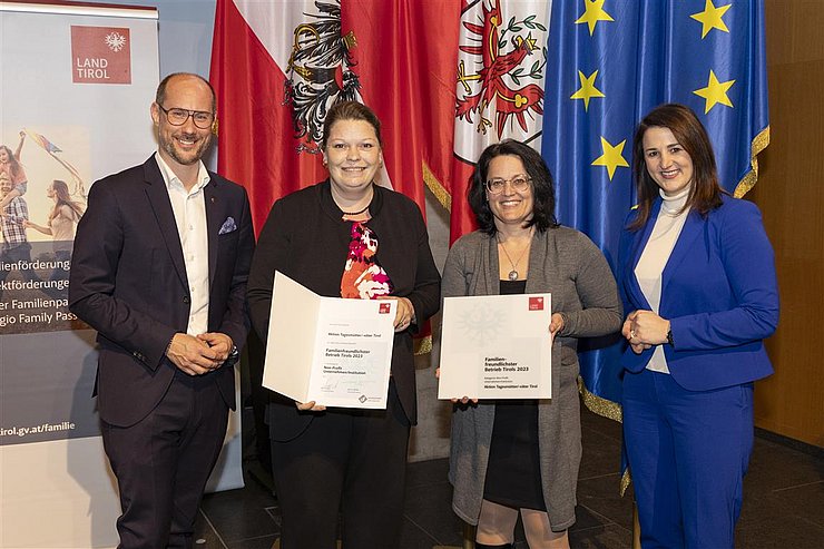 vier Personen mit Urkunde