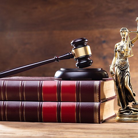 Close-up,Of,Golden,Lady,Justice,Near,Wooden,Gavel,Over,Law