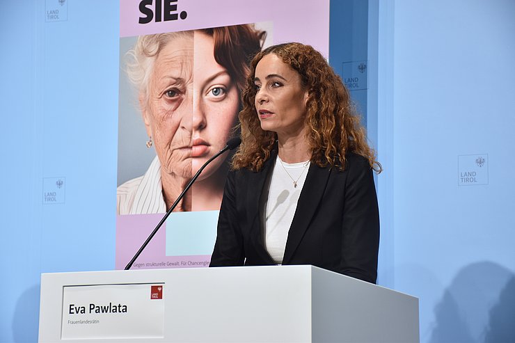 LRin Pawlata beim Sprechen am Redepult - in Hintergrund ist Sujet zu sehen