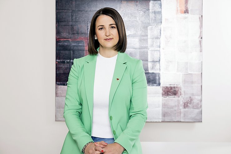 © Land Tirol/Sedlak Landesrätin Astrid Mair im Büro auf ihrem Schreibtisch sitzend