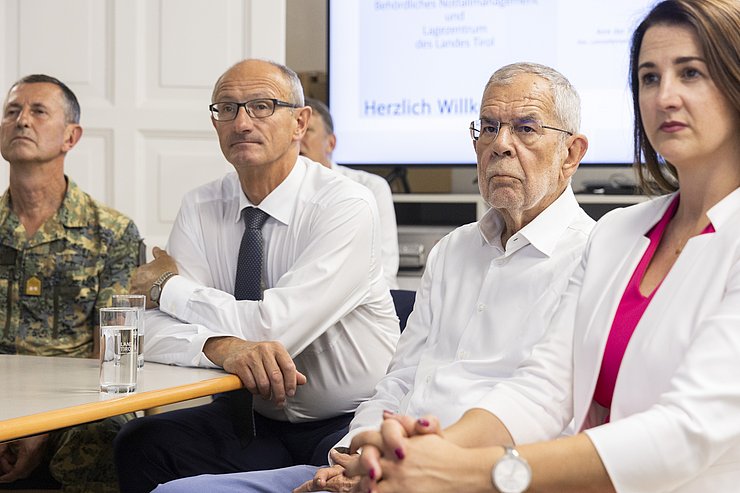 Mattle, Van der Bellen und Mair sitzen nebeneinander und sehen auf einen Bildschirm